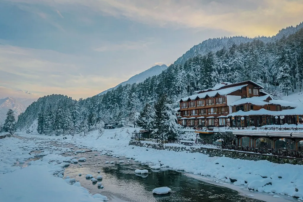 Lush pine forests and misty mountain peaks in Pahalgam